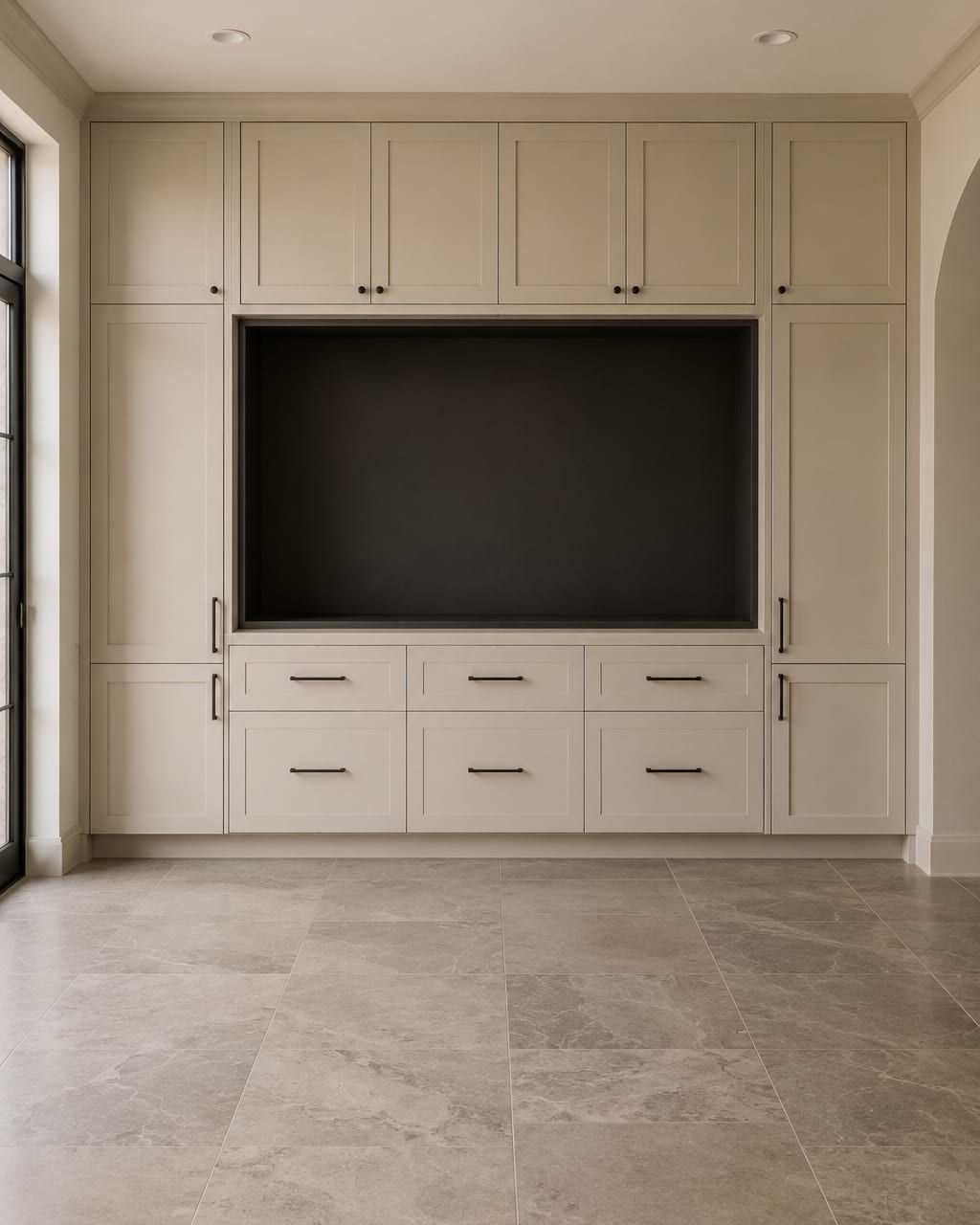 A painted built in media wall with open shelving above and cabinet doors below flanking a television