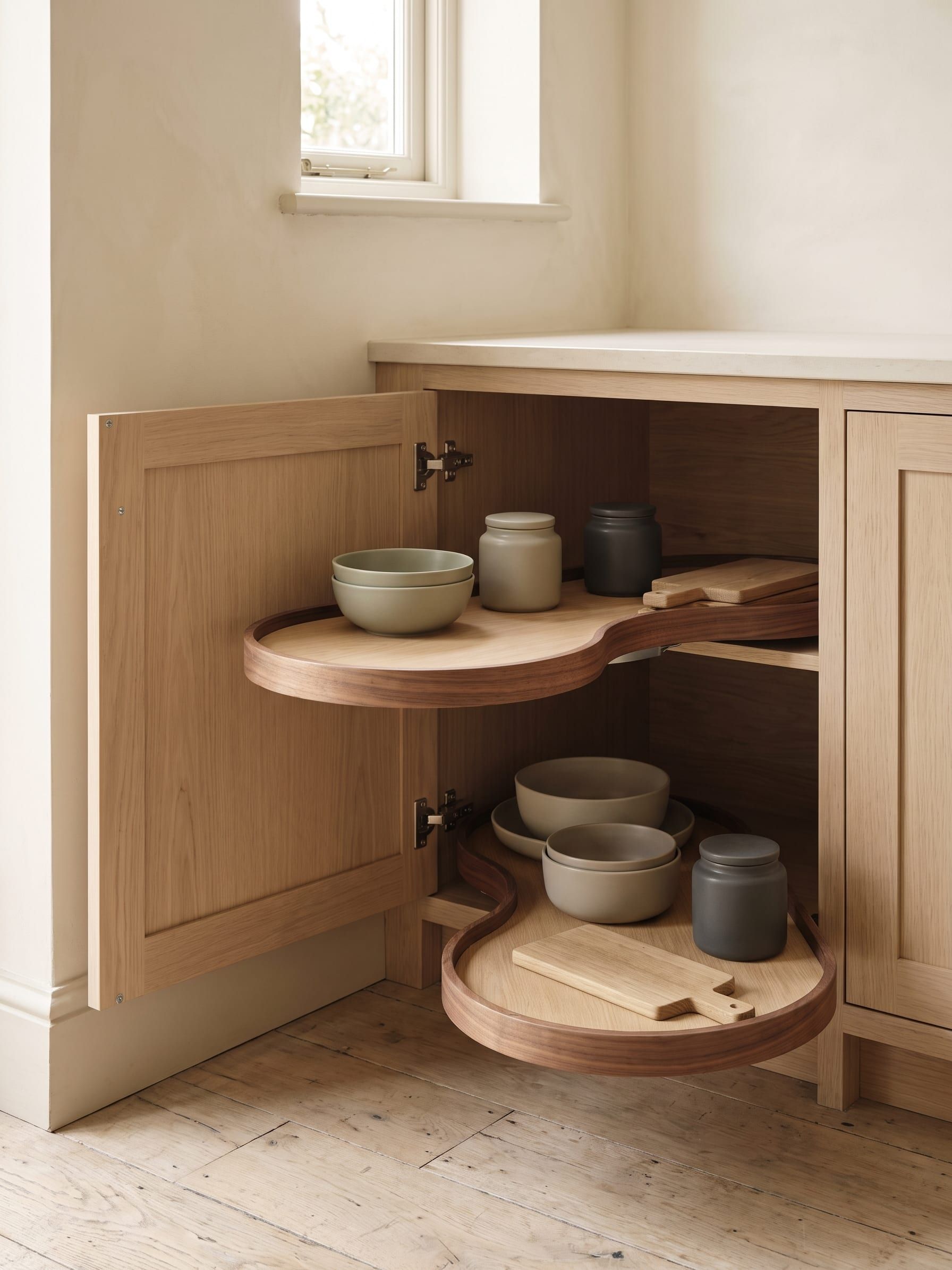 A corner base cabinet with a pull out unit swung out toward the room