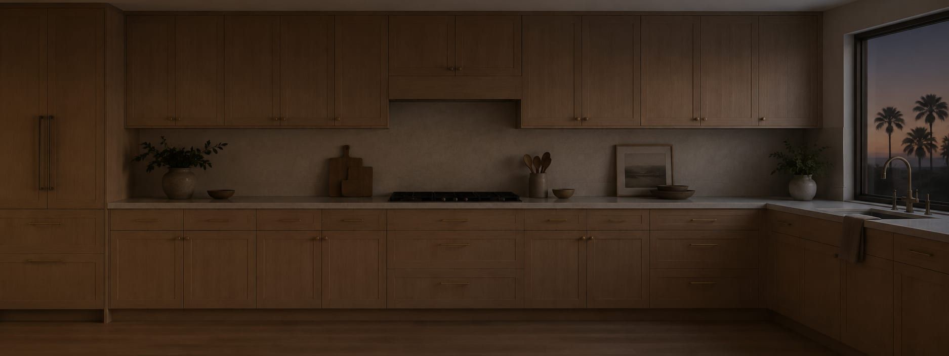 A finished kitchen seen from the dining side with morning light across the island